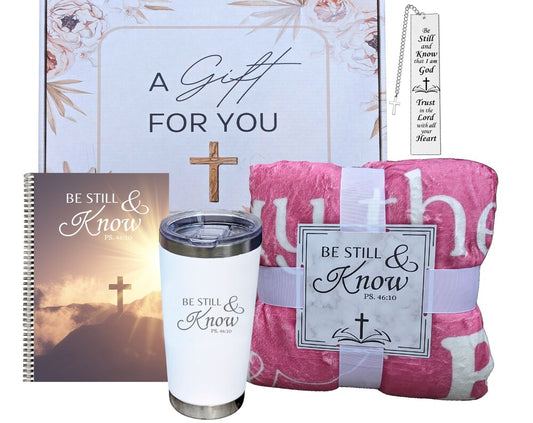 A collection of Christian-themed gifts including a pink throw blanket with Bible verses, a metal Bible verse bookmark, a spiral journal, and a tumbler with lid, all packaged in a gift box.
