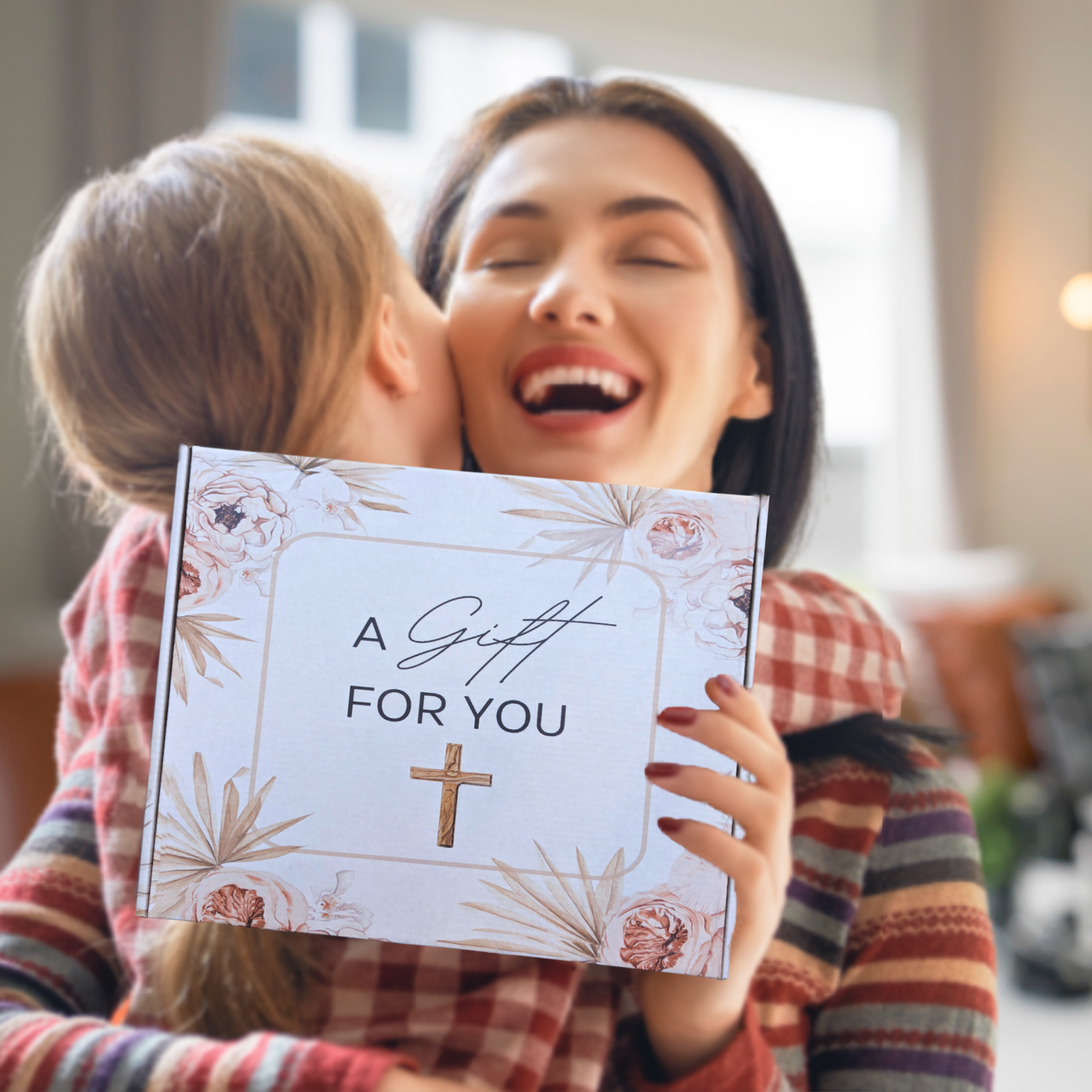 Woman hugging a child and a gift box with 'A Gift For You' text and cross symbol. Inspirational Gift for women.
