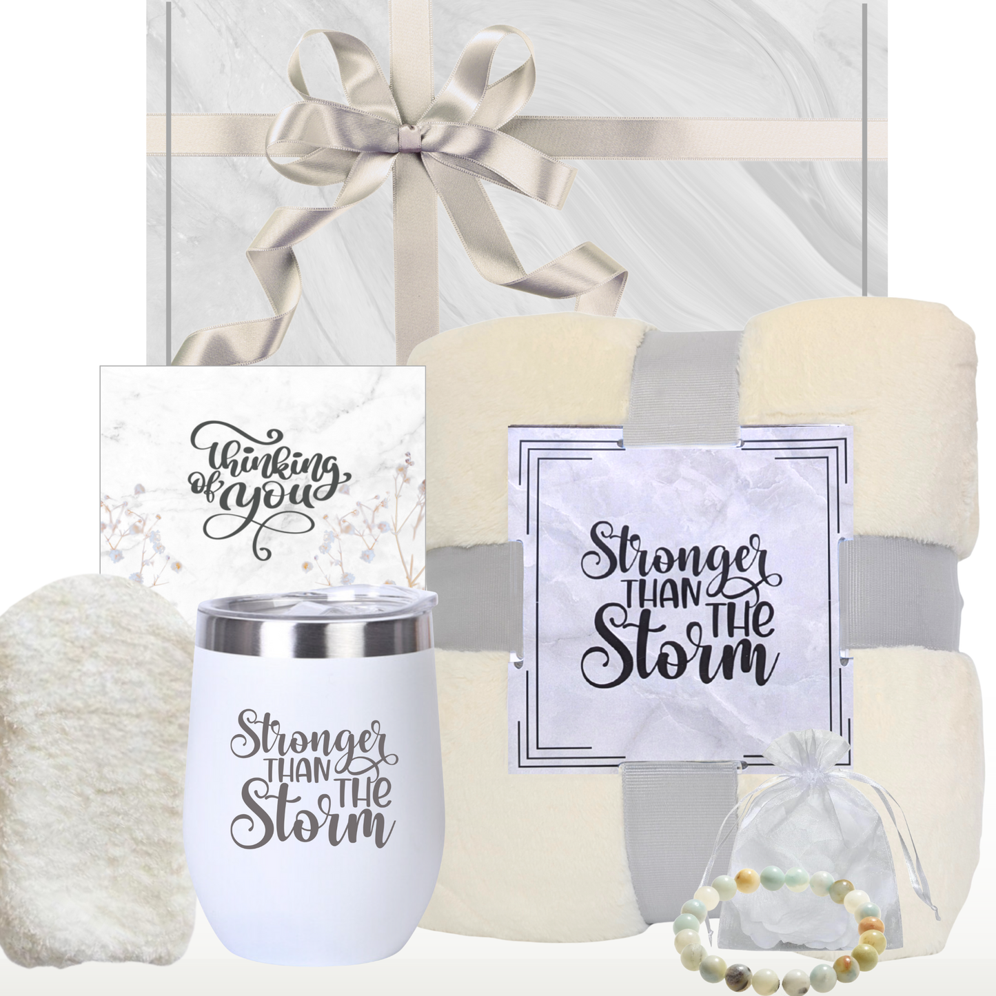 A gift box for women containing an ivory plush blanket, a white insulated wine tumbler with a lid, a natural stone bracelet, ivory socks and a 'Thinking of You' card, all ready to be gifted. All presented with a ‘Thinking of You’ and ‘Stronger Than The storm’ theme