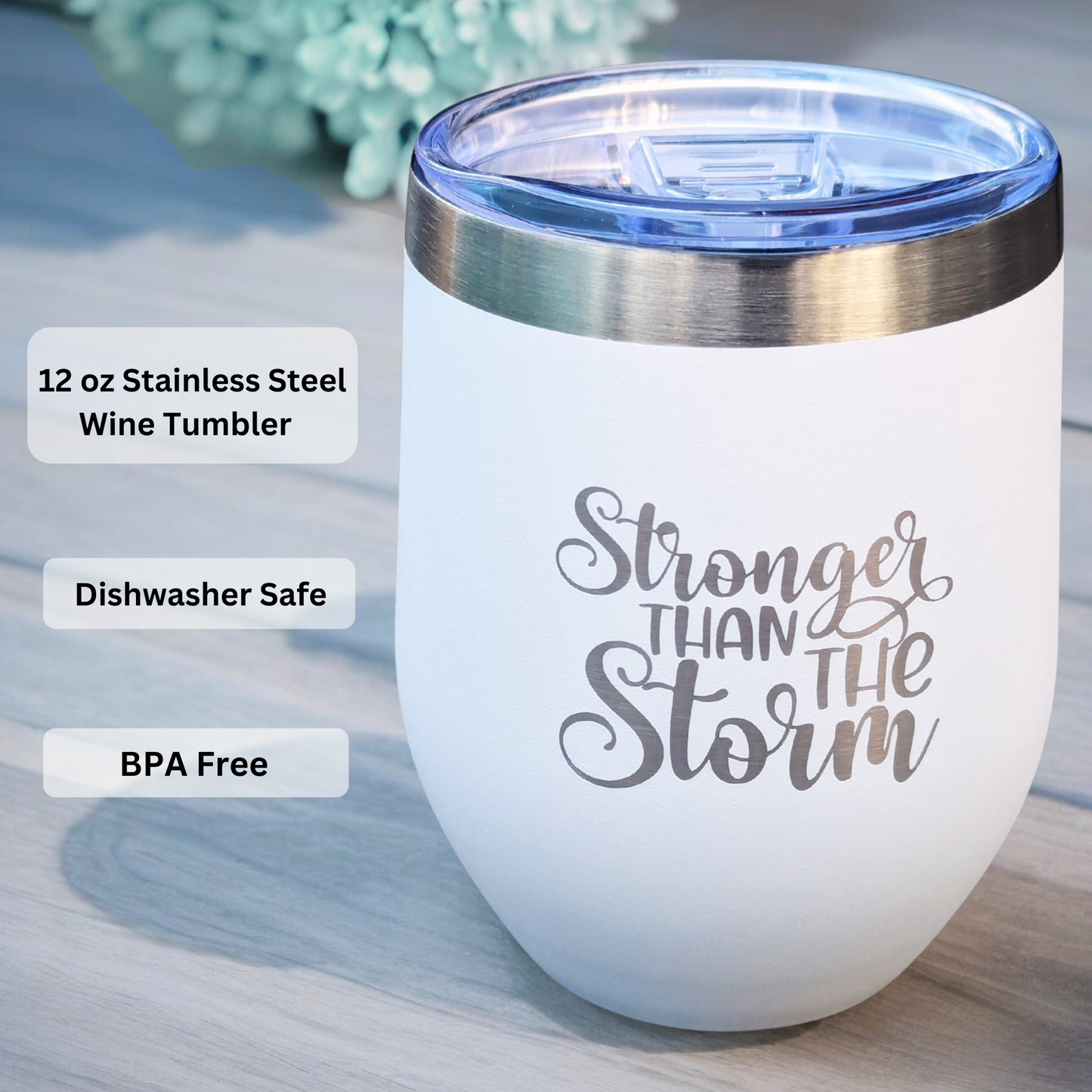 White stainless steel wine tumbler with 'Stronger Than The Storm' text on a light wooden surface. included in women's self-care gift box
