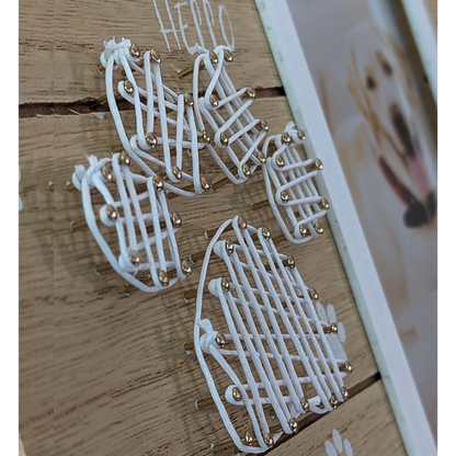 a close up of the White string art in the shape of a dog paw print on the pet memorial photo frame