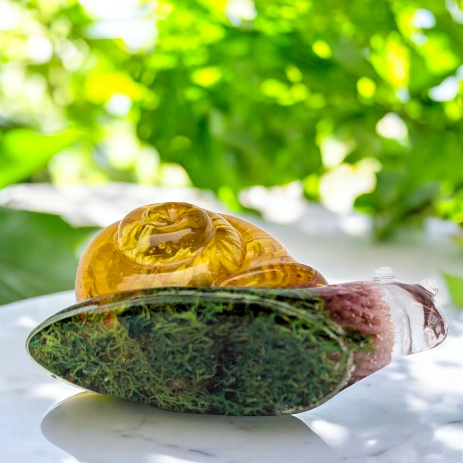 Bottom of a Nature-themed resin snail figurine with real dried flowers and moss – whimsical woodland decor accent